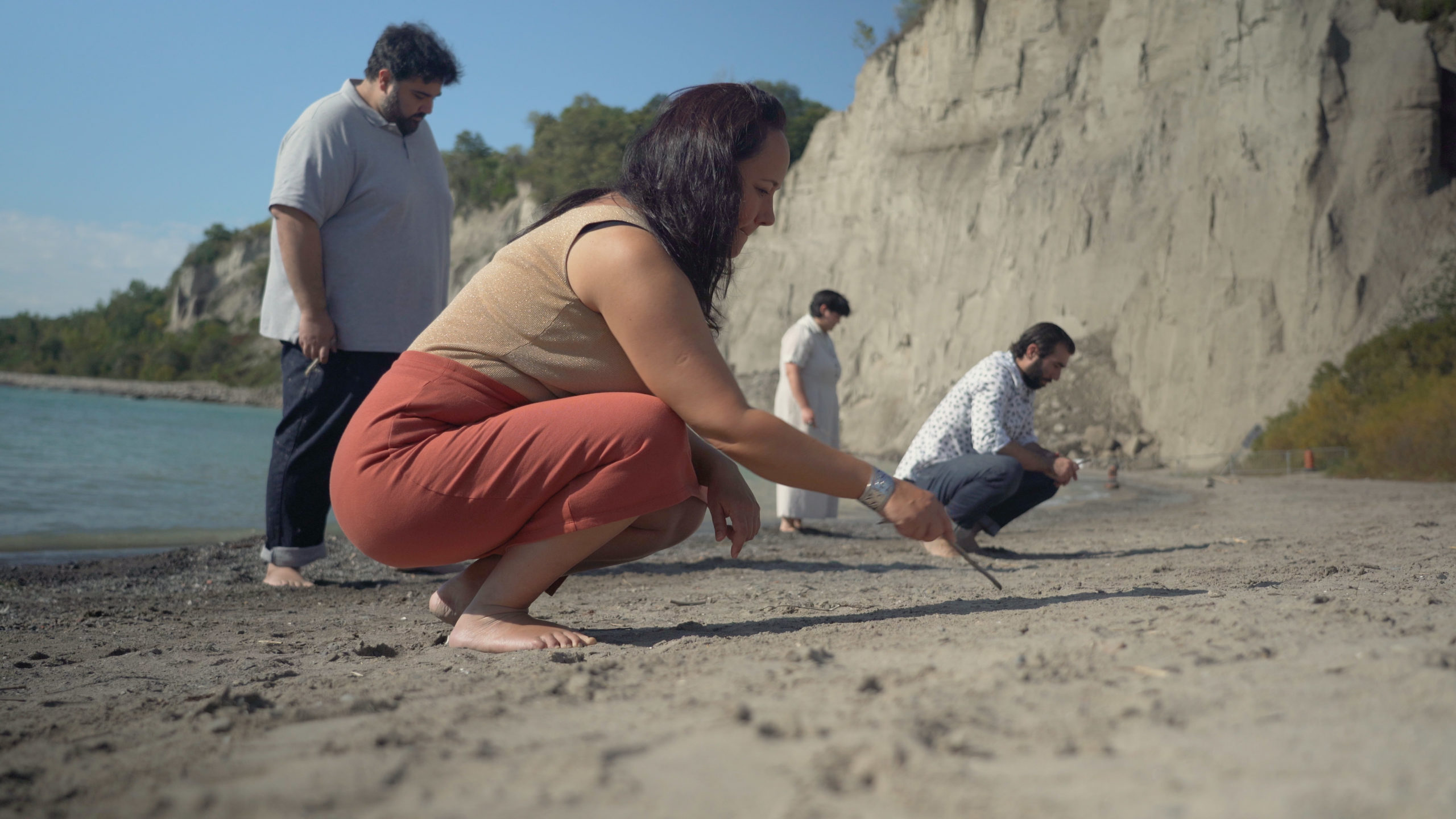 This image features the four requiem solists, Marion, Andrew, Midori, and Vartan writing in the sand.